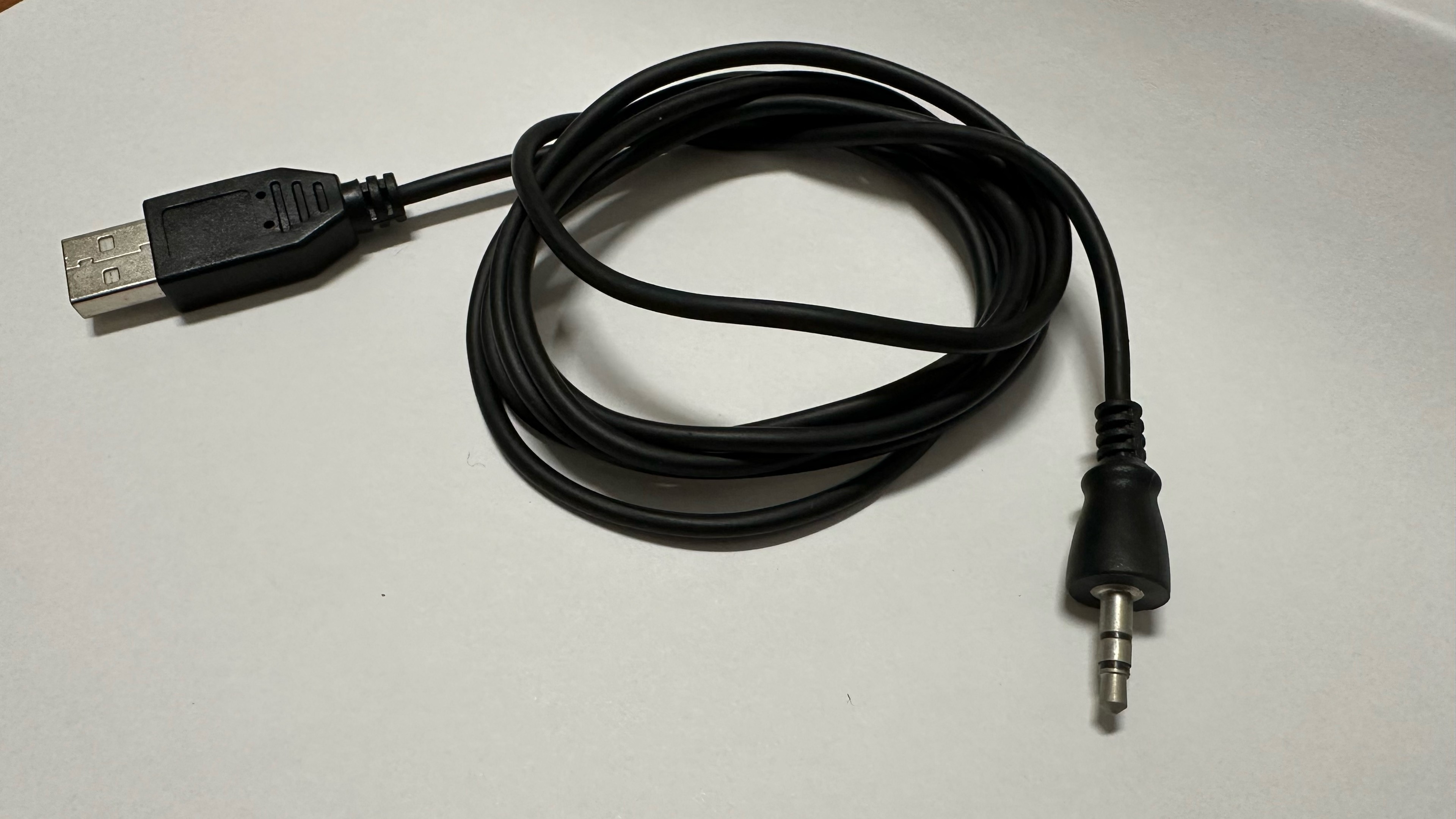 a coiled USB A connector with a 1/8" headphone plug on the other side