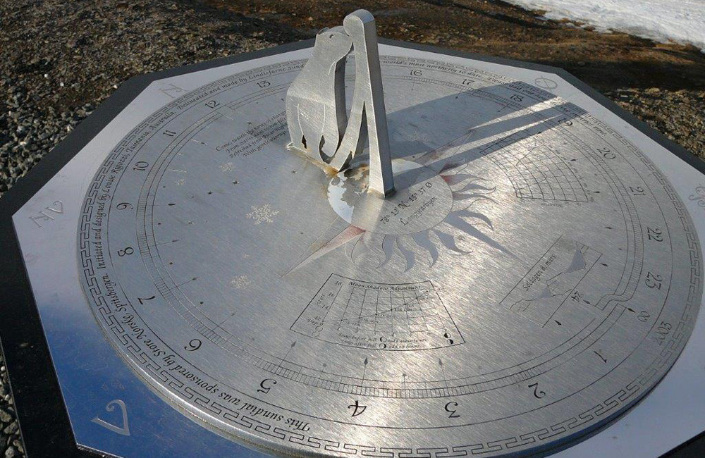 sundial with 24 hour markings for the arctic summer. the gnomon looks like a polar bear. this photo is from the website and does not have any license information.