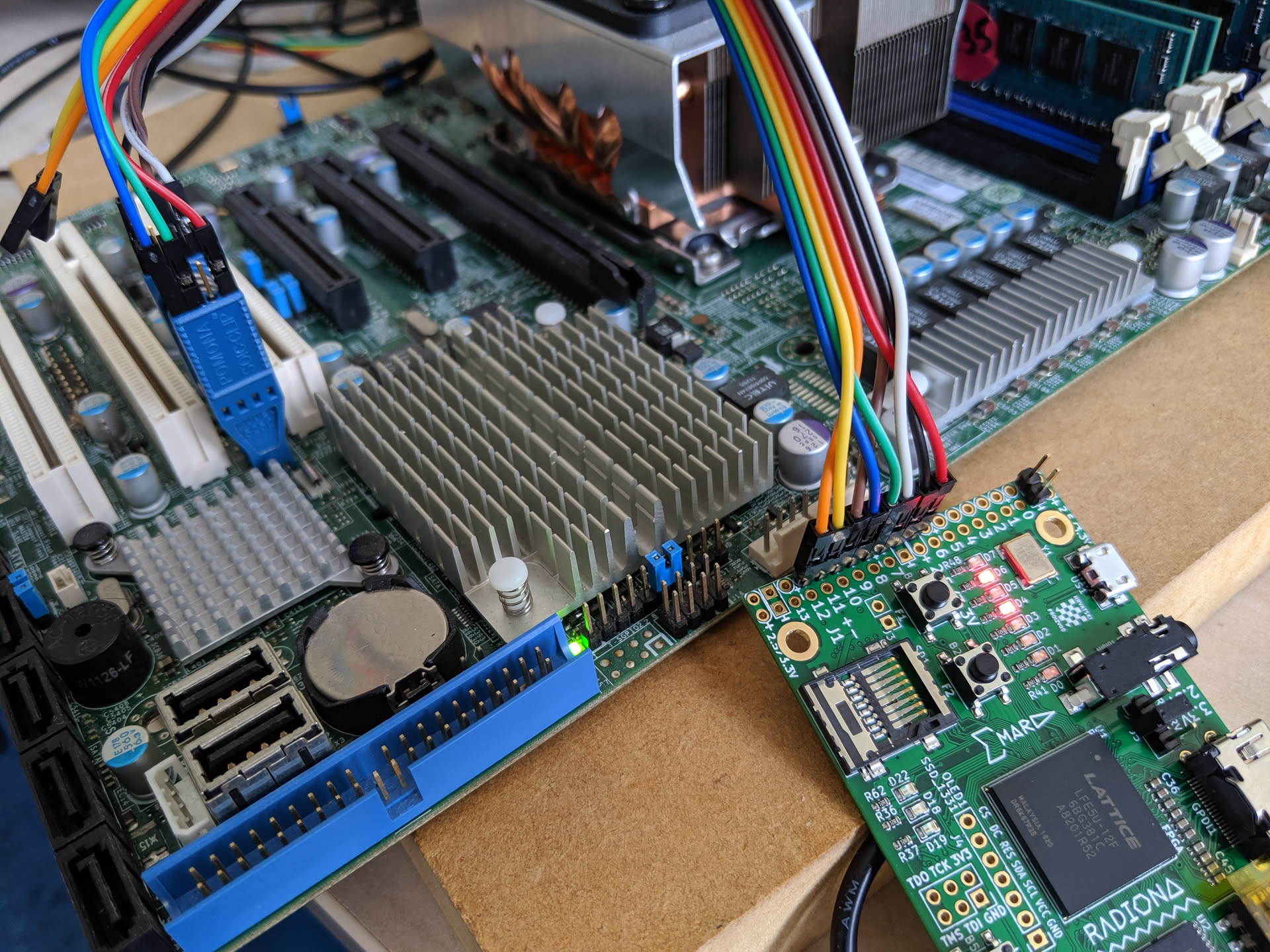 supermicro mainboard with an FPGA clipped to the 8-pin SPI flash chip