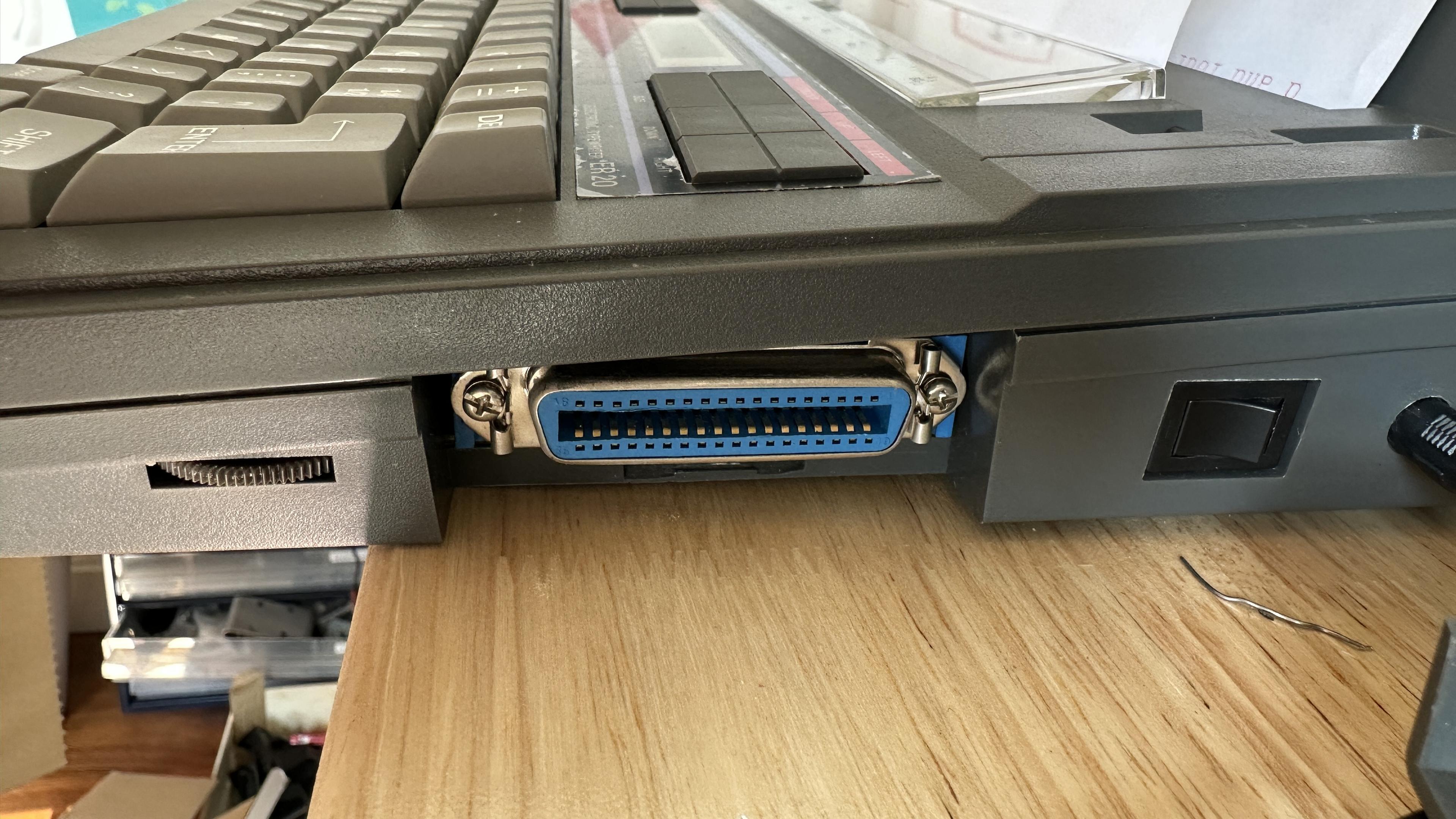Side of a typewriter with a 25 pin centronics parallel port (I think)