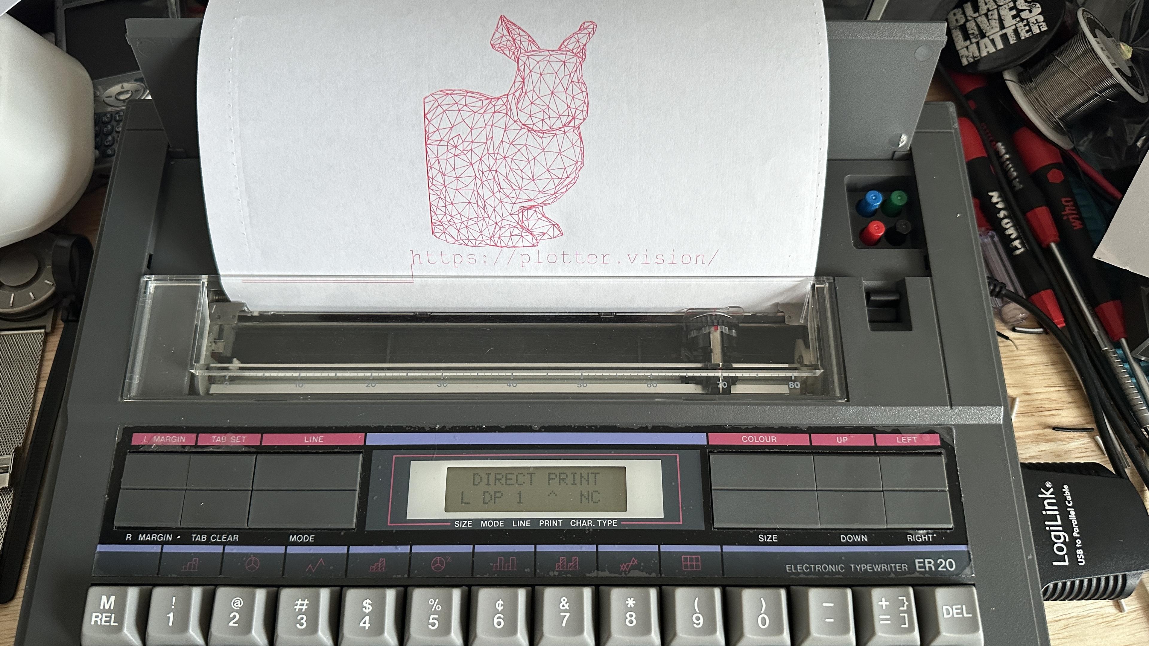 Wireframe bunny rendered by a typewriter in red lines. A large LogiLink usb adapter is plugged into the device. 